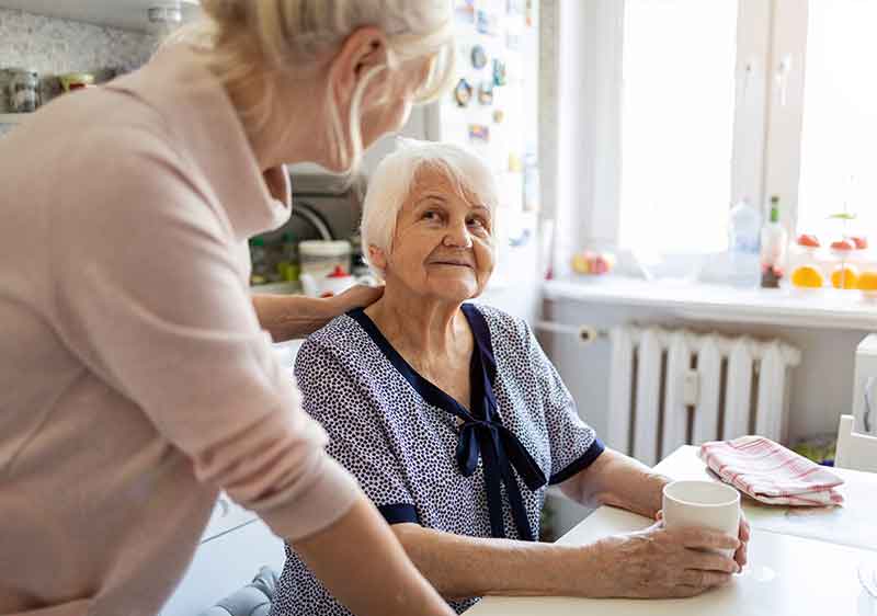 home carer and client talking about Care Cost Solutions