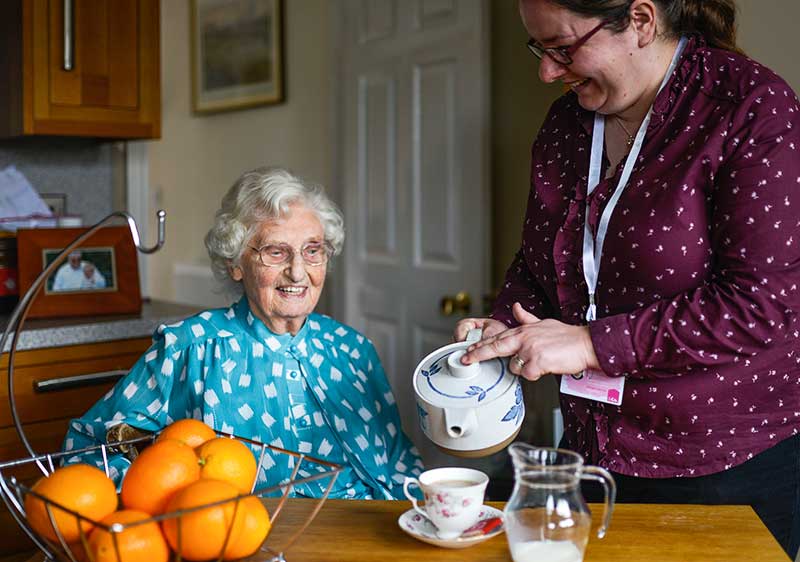 Home Care Lincoln - Carer pouring cup of tea for client
